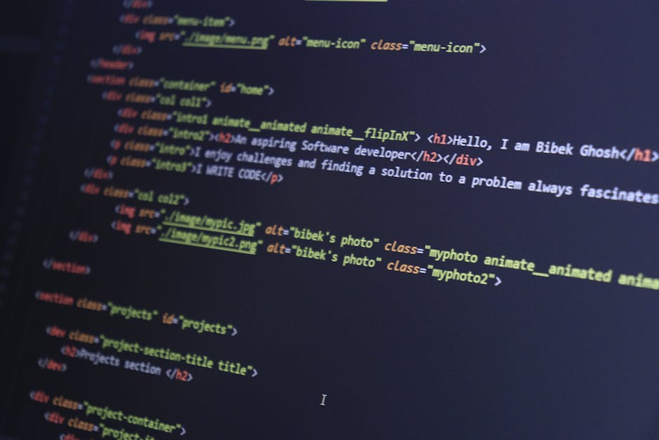 A close-up photograph of a computer screen displaying lines of HTML code with syntax highlighting in multiple colors such as yellow, blue, white, and red. The code contains tags, attributes, and image